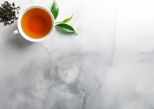 A cup of tea and plant on a gray stone table