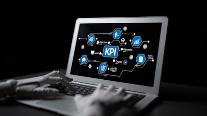 A robotic hand engages with a laptop screen displaying key performance indicators, highlighting technology and business strategy integration in a dark environment. Tessel