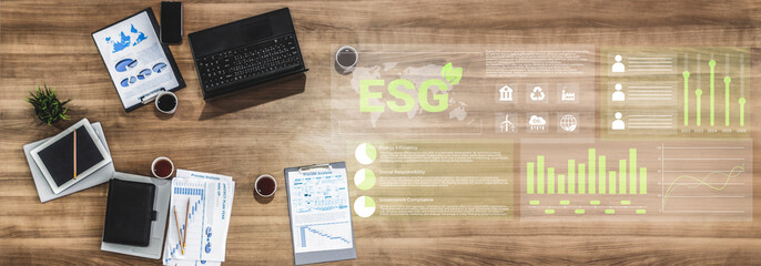 A modern office desk featuring ESG strategies with financial reports, charts, and a digital interface, symbolizing corporate responsibility and data analysis. Gantry