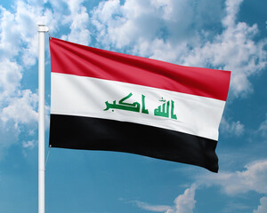 Realistic close-up of the Iraq flag waving on a tall flagpole under a bright sky with soft scattered clouds, showing smooth wind motion, vivid colors, and a clear, proud national atmosphere.
