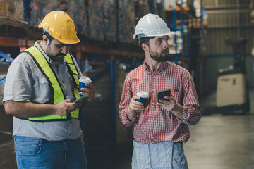 Warehouse worker working in warehouse storage. Foreman or worker work at factory site check up...