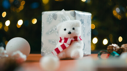 Christmas teddy bear next to a children's gift