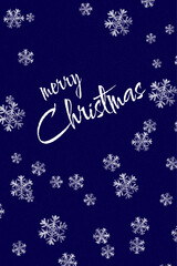 A festive greeting card featuring "Merry Christmas" in white cursive, surrounded by silver snowflakes against a dark blue, starry background. The design conveys a winter holiday mood.