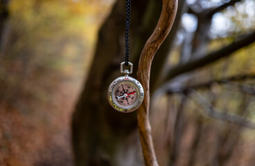 vintage compass on chain in forest