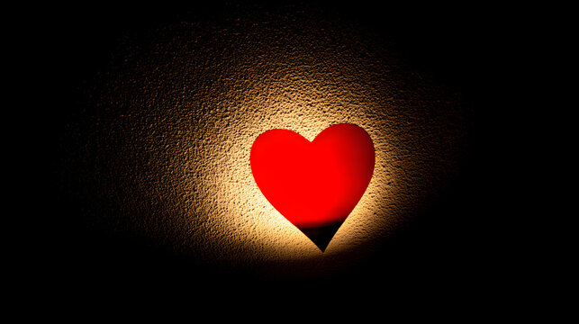 adoration. A red heart symbol stands out against a textured black background with a warm glow. wellbeing guides, coaching materials, designed for coaching and self-improvement content.