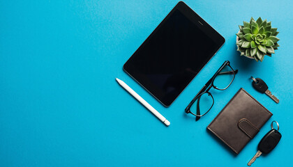 Modern workspace essentials elevate productivity and inspire creativity, featuring a sleek tablet, stylish glasses, keys, and a vibrant succulent