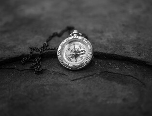  vintage compass on chain on rock