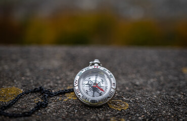 vintage compass on chain on rock