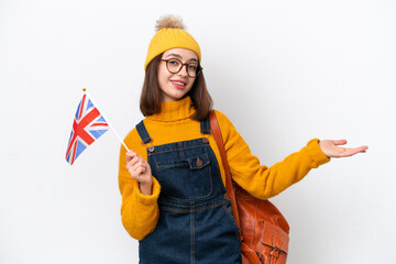 Young Ukrainian woman holding an United Kingdom flag isolated on white background extending hands to the side for inviting to come