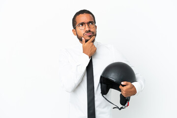 Young business latin man with a motorcycle helmet isolated on white background having doubts