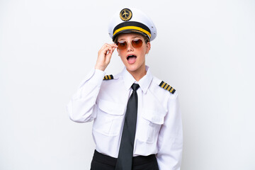 Airplane caucasian pilot woman isolated on white background with glasses and surprised