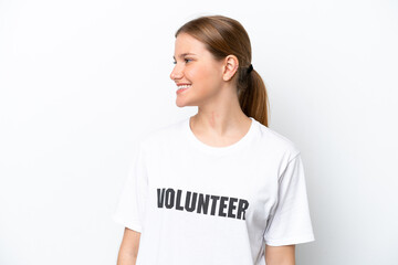 Young volunteer woman isolated on white background looking side