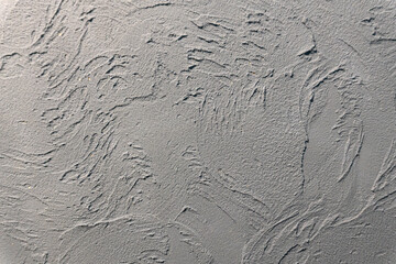 Abstract artistic background: textured plaster surface with hand-applied tool strokes. Ideal for graphic design projects, website headers, and creative presentations