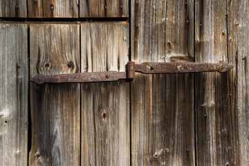 Rusty Hinged Wooden Door with Weathered Texture in Vintage Style