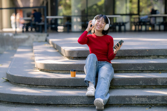 Happy young woman enjoying music on headphones