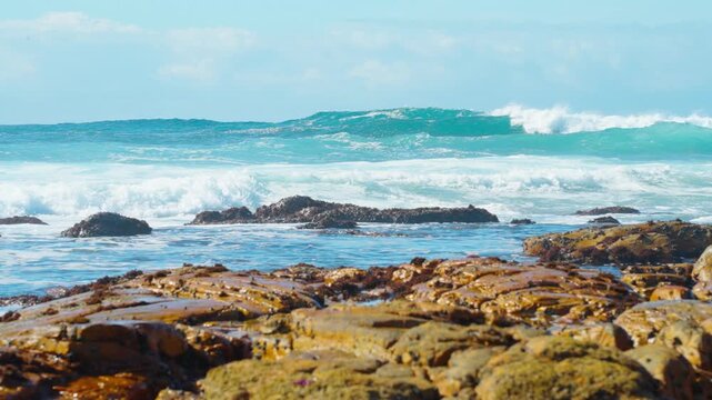 Slow motion, layers of blue giant waves rolling on the sea under the sunlight