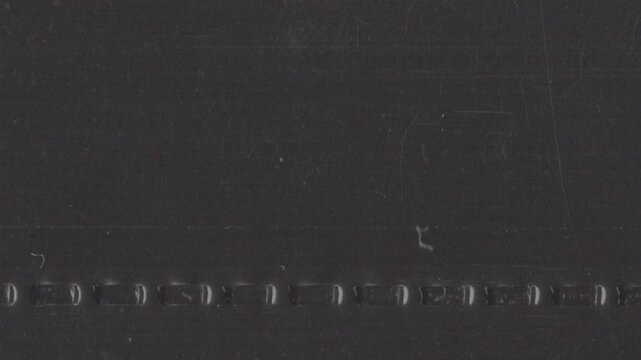 Vertical analog film grain loop with grind texture, dust and subtle imperfections. Ideal as an overlay or background for editors seeking authentic retro looks in vertical format.