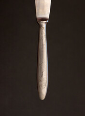 Metal knife handle on a black background.