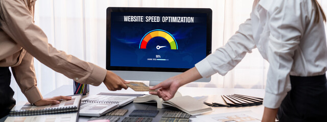 Group of interior architect designer team at table choosing various mood board samples with architecture software on laptop screen. Modern renovation and interior material selection concept. Insight