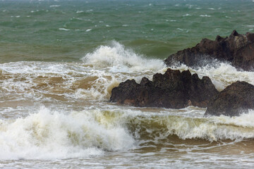 Stormy ocean waves crashing against coastal rocks in Sri Lanka
