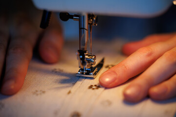 Crafting delicate stitches with precision in a cozy sewing space during evening hours