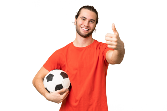 Young handsome man isolated on green chroma background with soccer ball and with thumb up