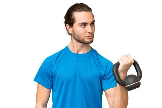 Young handsome man isolated on green chroma background making weightlifting with kettlebell
