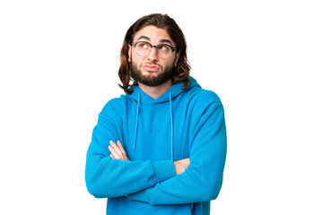 Young handsome man over isolated chroma key background making doubts gesture while lifting the...