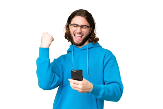 Young handsome man over isolated chroma key background with phone in victory position