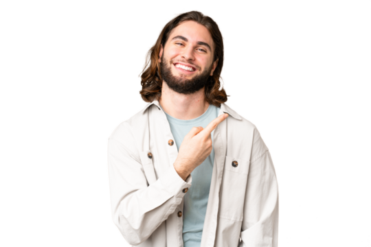 Young handsome man over isolated chroma key background pointing to the side to present a product