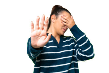 Young beauty woman over isolated chroma key background making stop gesture and covering face