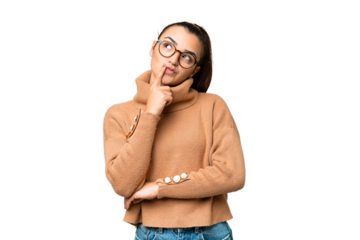 Young beauty woman over isolated chroma key background having doubts while looking up