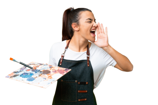 Young artist woman holding a palette over isolated chroma key background shouting with mouth wide open to the side