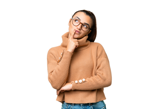 Young beauty woman over isolated chroma key background having doubts while looking up - Powered by Adobe