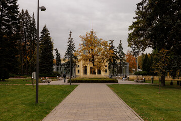 Stunning autumn scene featuring a historic building surrounded by vibrant foliage in a serene park setting