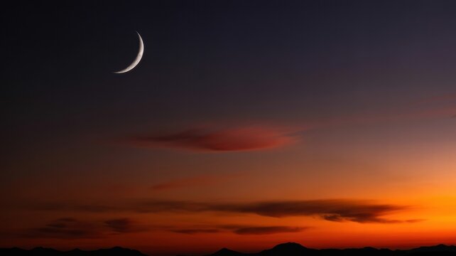 A crescent moon in a dark sky with orange and purple clouds during a vibrant sunset or sunrise view - Powered by Adobe