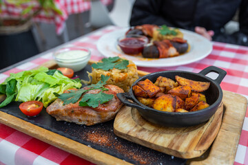 Estonian pork meal with potatoes, cabbage and salad, Estonia.