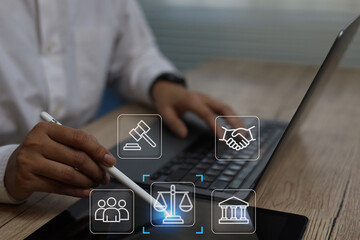 Professional hand using pen pointing tablet working on device with justice icons, representing online legal services compliance, digital law data protection and modern business regulations the digital
