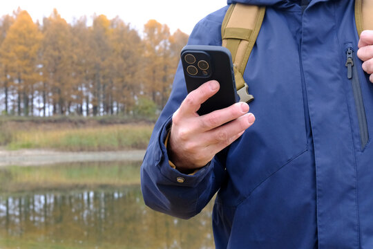 Man navigating with smartphone during autumn hike