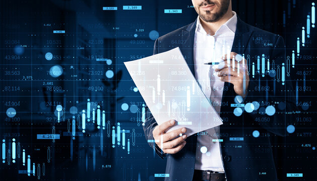 Businessman analyzing financial report with digital stock market chart overlays on dark background illustrating investment data and growth trends.
