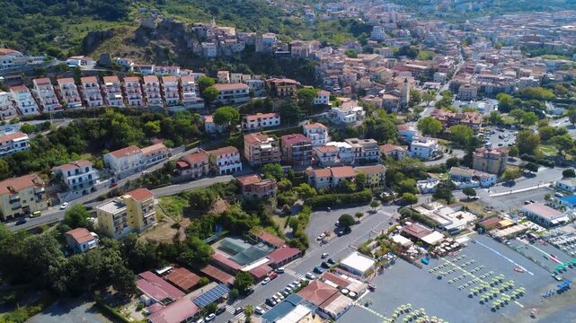 Stunning Aerial View of Coastal Town With Vibrant Buildings and Marina During Bright Sunny Day. Scalea, Calabria, Italy