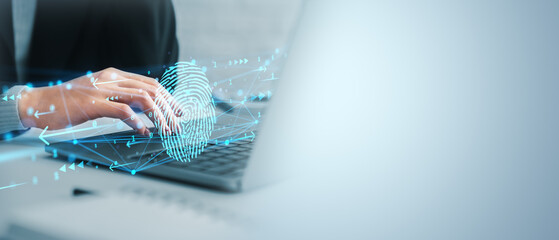 Business person using fingerprint authentication technology on laptop keyboard with digital hologram elements on light blue background concept.