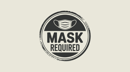 Fototapeta premium A circular sign with a mask icon and the words mask required in bold black letters on a light background