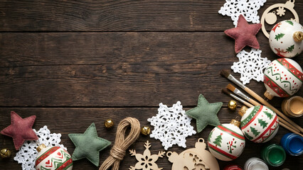 Festive holiday flat lay ornaments craft project on rustic wooden surface
