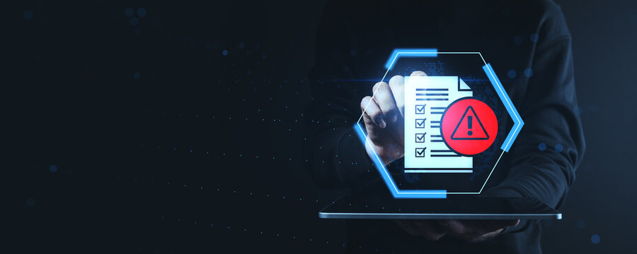 Cybersecurity warning concept showing checklist with alert icon on futuristic interface held above tablet on dark digital background.