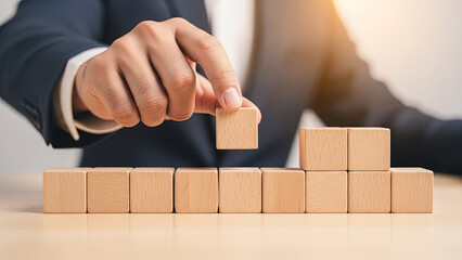 Businessman hand stacking wooden cubes block creating step stair concept business development growth strategy success building foundation future planning career progress