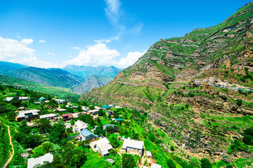 Beautiful view of the mountain village against the slope with ancient ruins of the village of Kakhib. North Caucasus