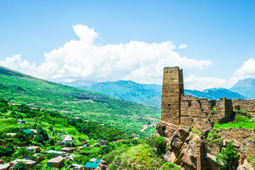 An old watchtower among the ruins of the abandoned mountain village of Kakhib on a mountainside. North Caucasus