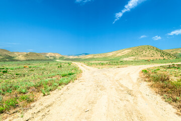 Picturesque landscape on a rural dirt road in the semi-desert of the North Caucasus mountains