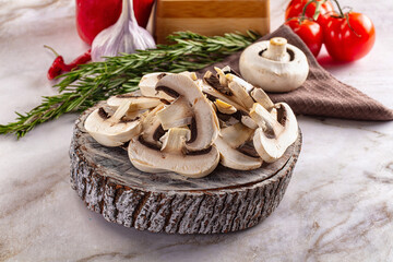 Raw champignon slices on the board
